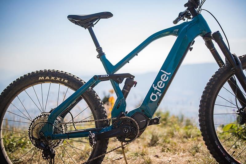 An electric O2feel mountain bike on a mountain ridge